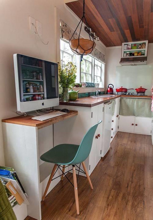 Vì diện tích không quá lý tưởng, do đó cạnh khu vực phòng bếp, gia chủ đã khéo léo bố trí thêm chiếc bàn đặt máy tính làm nơi làm việc